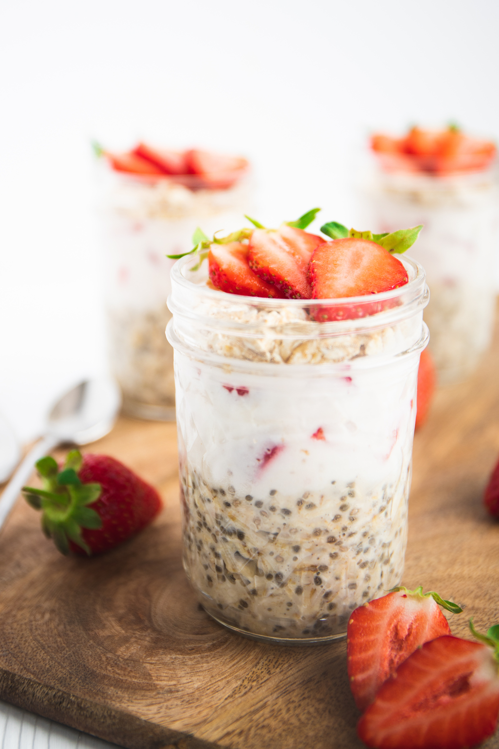 layers of overnight oats and strawberries in a jar