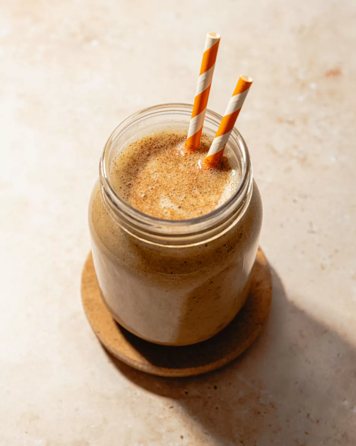 date shake in a glass with two straws